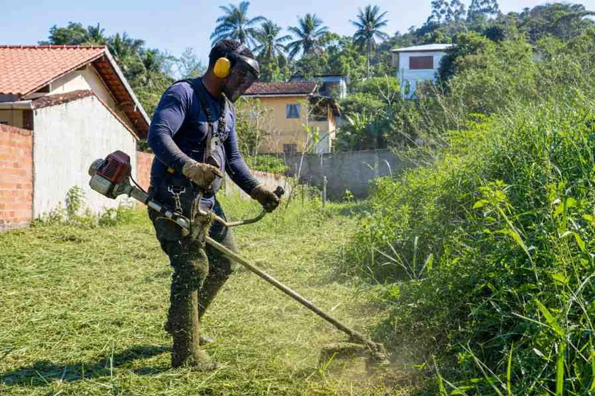 Profissional realizando limpeza de terreno e roçagem de mato alto com roçadeira em Rio Vermelho